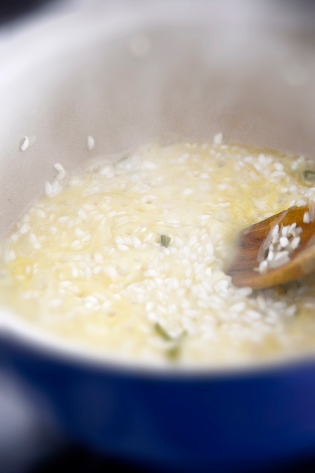 the oil coated rice is slowly cooked in hot stock and white wine